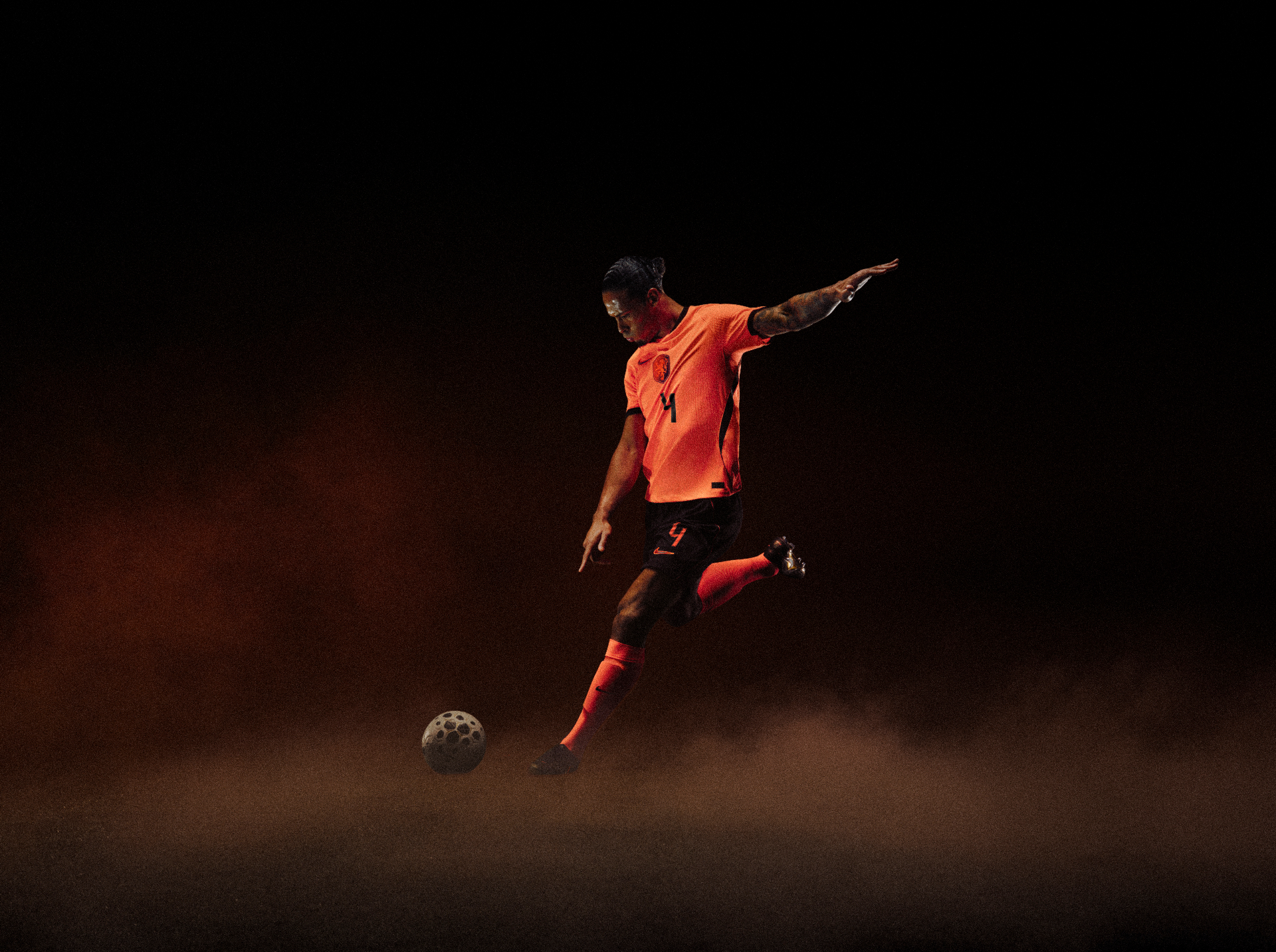 Virgil van Dijk in the Netherlands national team kit striking a ball